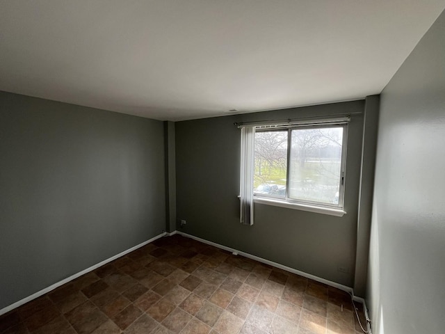 300 Park Ave Unit 236, Calumet City, IL 60409 - empty room featuring stone finish flooring and baseboards