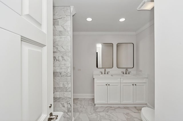 full bath featuring marble finish floor, ornamental molding, and a sink