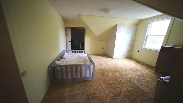 309 W 5th St, Minonk, IL 61760 - bedroom featuring carpet floors, vaulted ceiling, and wooden walls