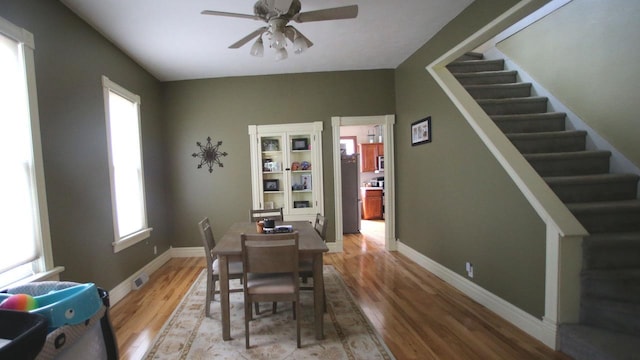 309 W 5th St, Minonk, IL 61760 - dining area with a ceiling fan, light wood finished floors, stairs, and baseboards