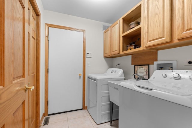 828 Wedgewood Dr, Crystal Lake, IL 60014 - washroom featuring cabinet space, washer and dryer, and light tile patterned floors