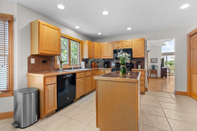 828 Wedgewood Dr, Crystal Lake, IL 60014 - kitchen with black appliances, a center island, plenty of natural light, tasteful backsplash, and recessed lighting