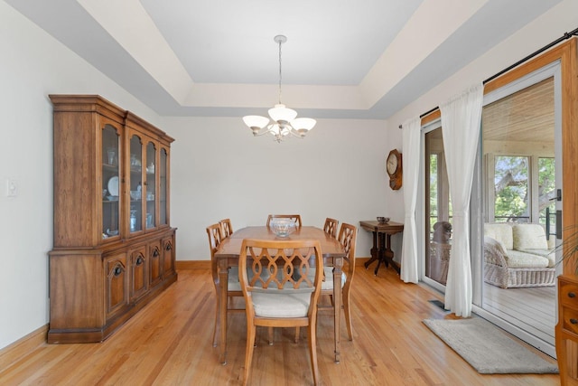 828 Wedgewood Dr, Crystal Lake, IL 60014 - dining room featuring a tray ceiling, a chandelier, and light wood-style floors
