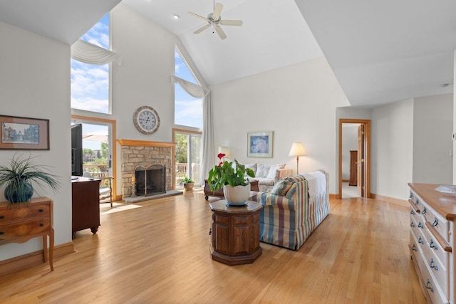 828 Wedgewood Dr, Crystal Lake, IL 60014 - living room featuring high vaulted ceiling, light wood-style flooring, ceiling fan, and a stone fireplace