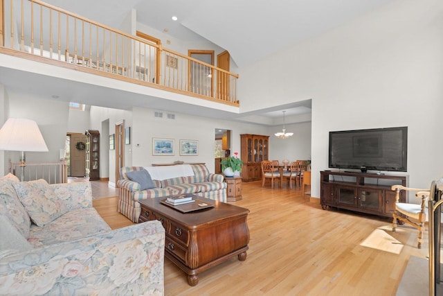 828 Wedgewood Dr, Crystal Lake, IL 60014 - living room featuring a towering ceiling, wood finished floors, a chandelier, and recessed lighting