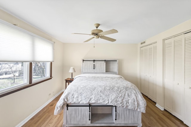 915 N Saratoga Dr, Palatine, IL 60074 - bedroom featuring baseboards, wood finished floors, multiple closets, and visible vents