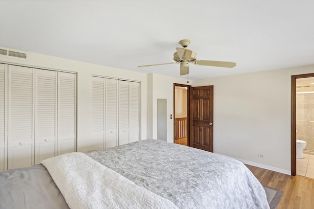 915 N Saratoga Dr, Palatine, IL 60074 - bedroom featuring light wood-type flooring, baseboards, visible vents, multiple closets, and connected bathroom