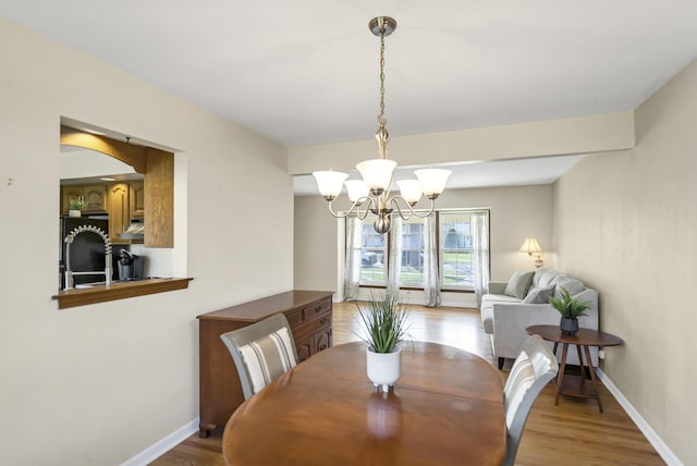 915 N Saratoga Dr, Palatine, IL 60074 - dining room with light wood-type flooring, baseboards, and a chandelier