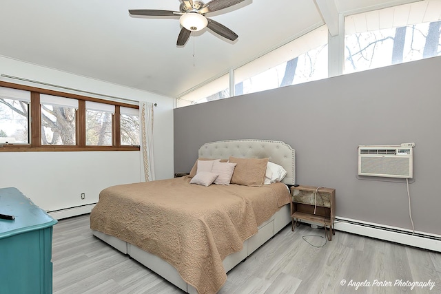 bedroom featuring vaulted ceiling, a wall mounted air conditioner, a baseboard heating unit, and wood finished floors