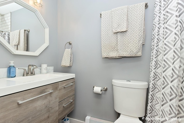 bathroom featuring toilet and vanity