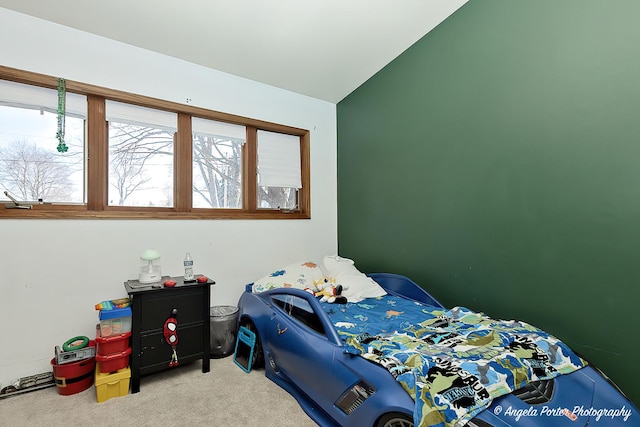 bedroom with vaulted ceiling and carpet