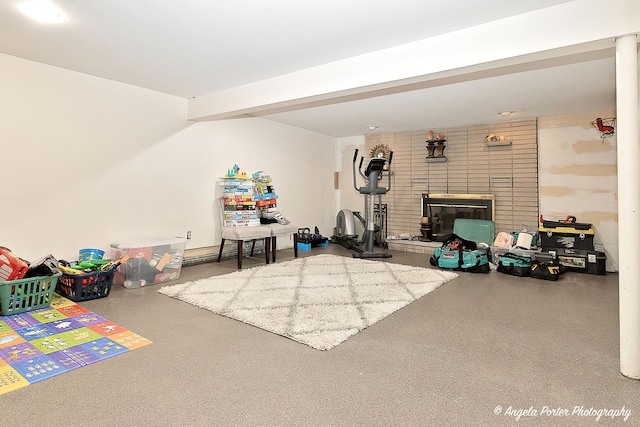 rec room with speckled floor and a fireplace