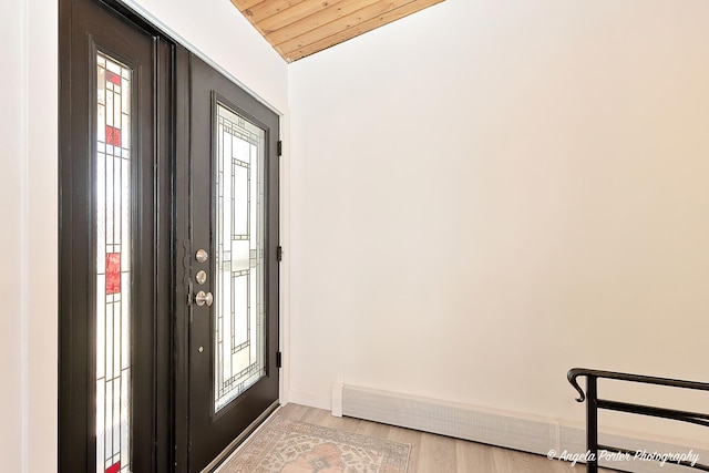 foyer with wood ceiling, baseboards, and light wood finished floors