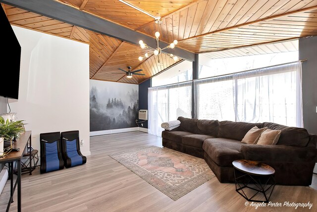 living room featuring a wealth of natural light, wood finished floors, vaulted ceiling with beams, and a chandelier
