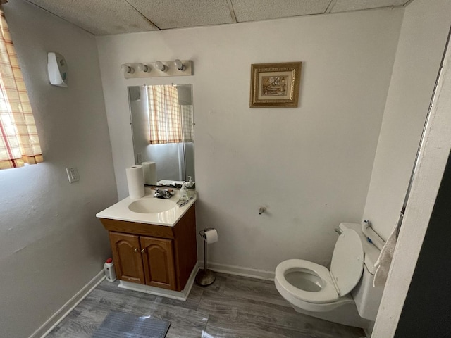 221 Heine Ave, Elgin, IL 60123 - half bath with vanity, a paneled ceiling, wood finished floors, and toilet