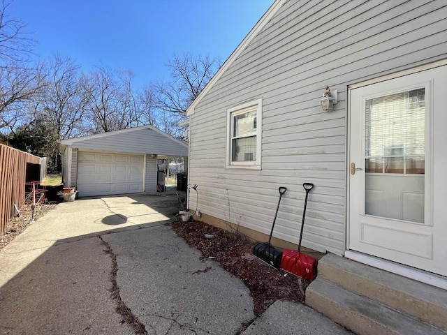 221 Heine Ave, Elgin, IL 60123 - view of property exterior with a detached garage, an outdoor structure, entry steps, and aphalt driveway