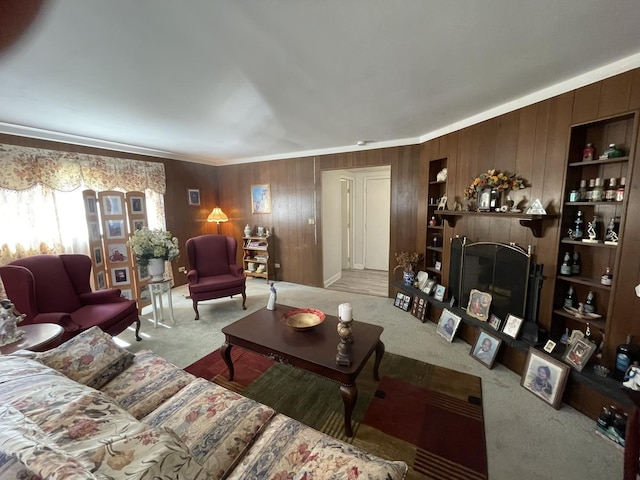 221 Heine Ave, Elgin, IL 60123 - living area featuring carpet flooring, wooden walls, a fireplace with raised hearth, and ornamental molding