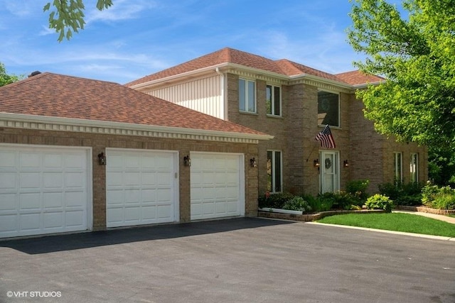 307 Anne Ct, Prospect Heights, IL 60070 - view of front of house featuring asphalt driveway, an attached garage, and a shingled roof