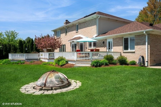 307 Anne Ct, Prospect Heights, IL 60070 - back of property with a fire pit, a yard, and a wooden deck