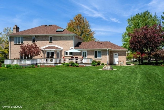307 Anne Ct, Prospect Heights, IL 60070 - rear view of property featuring a deck, a chimney, a lawn, and a fire pit