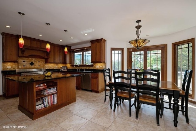 307 Anne Ct, Prospect Heights, IL 60070 - kitchen with stainless steel dishwasher, dark countertops, tasteful backsplash, light tile patterned flooring, and a center island