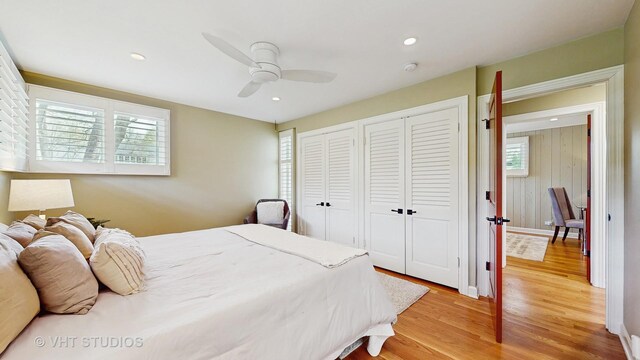 bedroom with a ceiling fan, two closets, recessed lighting, and light wood-style flooring