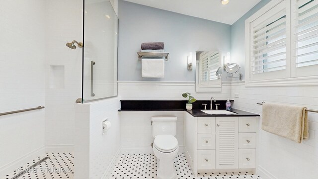 full bath with vaulted ceiling, a walk in shower, vanity, and toilet