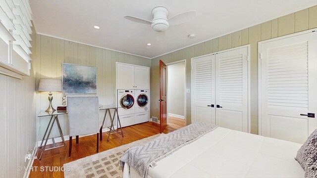 bedroom featuring washer and dryer, crown molding, and wood finished floors