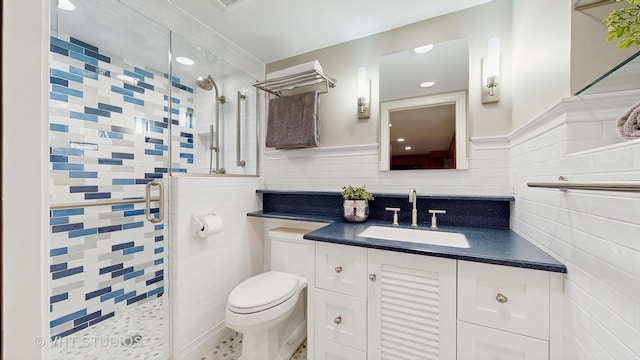 full bath with vanity, toilet, tile walls, recessed lighting, and a stall shower