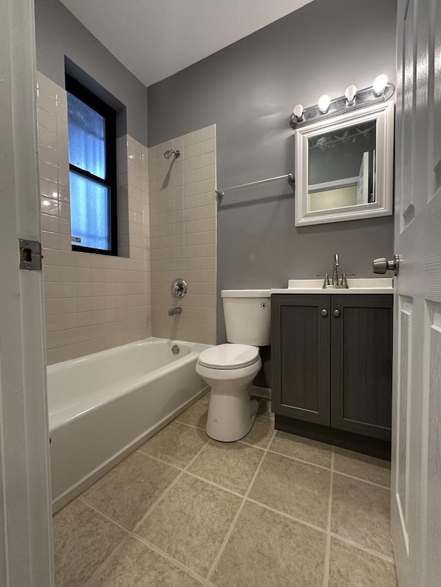 bathroom featuring shower / washtub combination, vanity, tile patterned flooring, and toilet