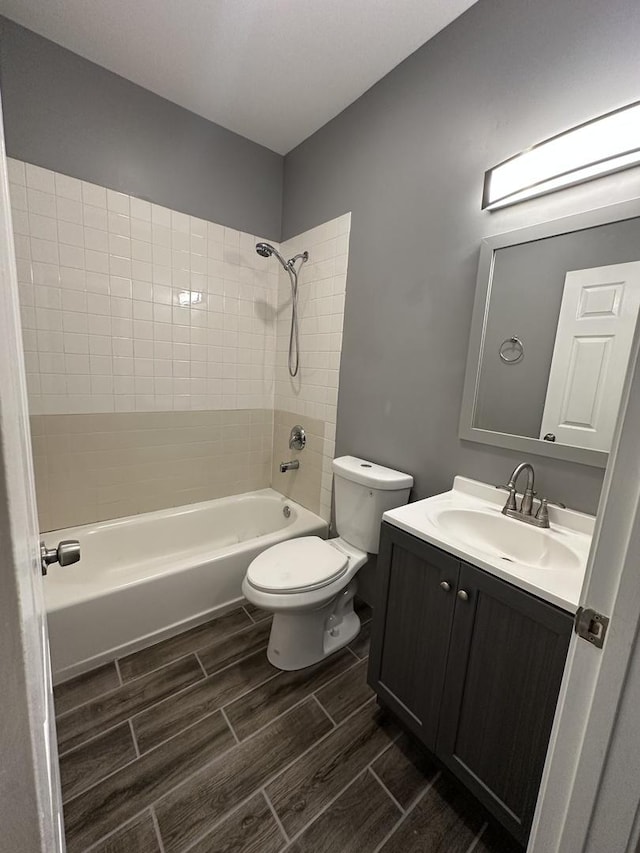full bath featuring shower / bathing tub combination, wood tiled floor, toilet, and vanity