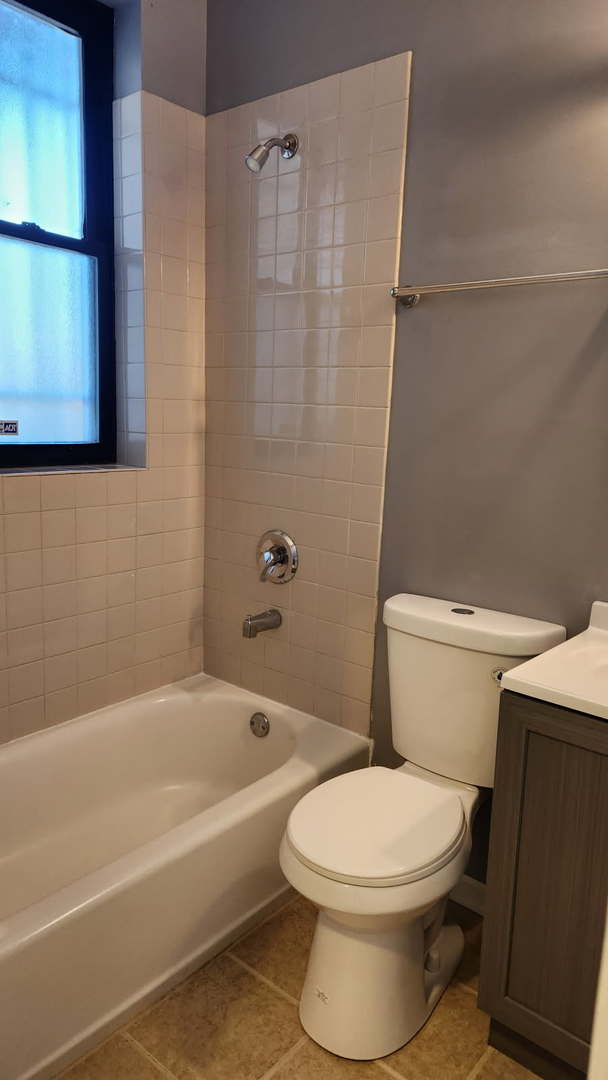 bathroom with vanity, shower / washtub combination, toilet, and tile patterned flooring