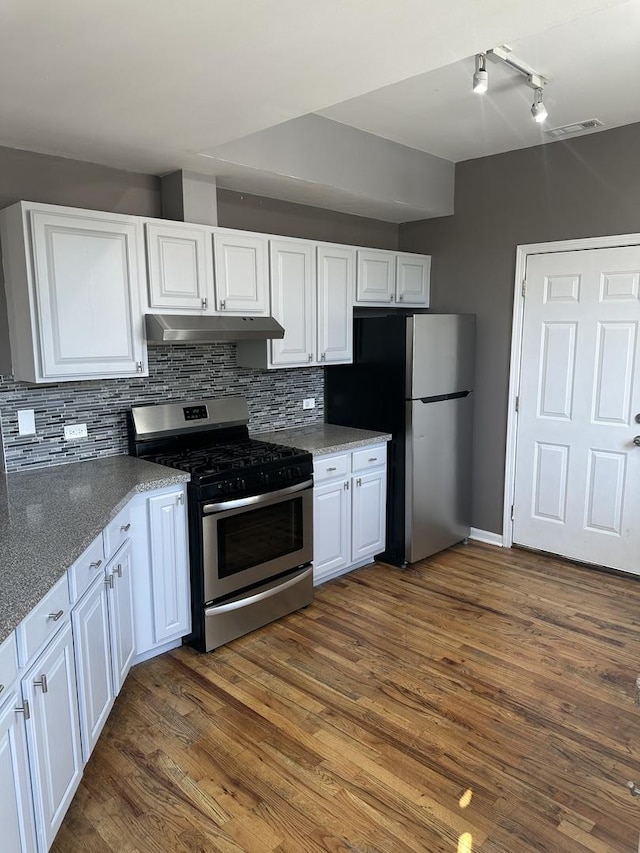 kitchen featuring white cabinets, tasteful backsplash, appliances with stainless steel finishes, and under cabinet range hood