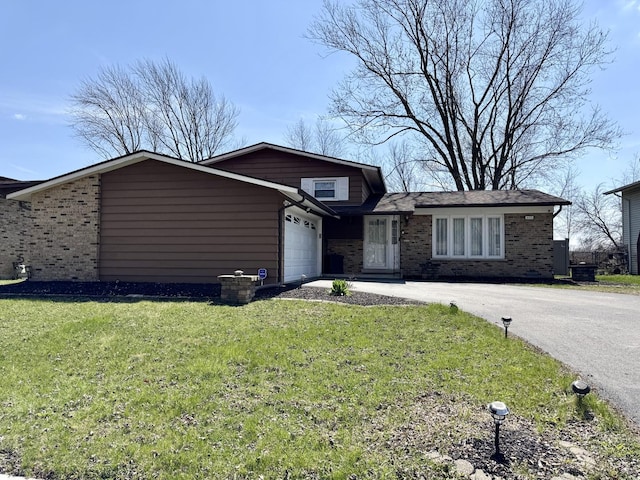 5125 Imperial Dr, Richton Park, IL 60471 - view of front of property with a front yard, brick siding, driveway, and an attached garage