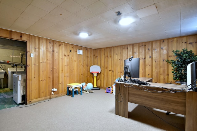 bedroom with washer / clothes dryer, carpet, and wood walls