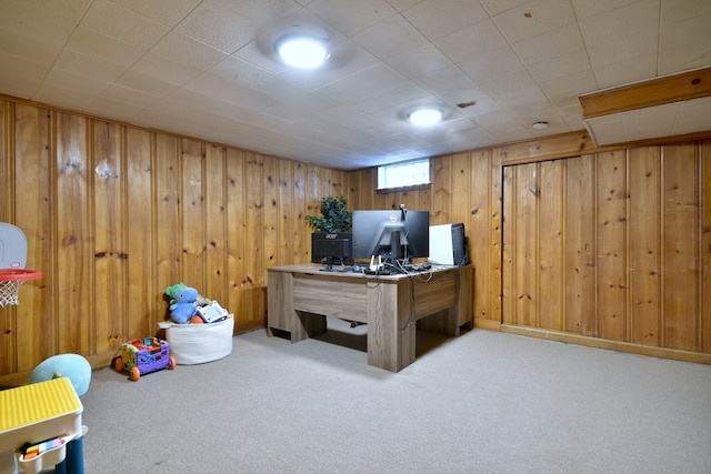unfurnished office with wood walls and carpet flooring
