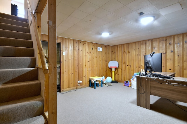 recreation room featuring carpet flooring and wooden walls