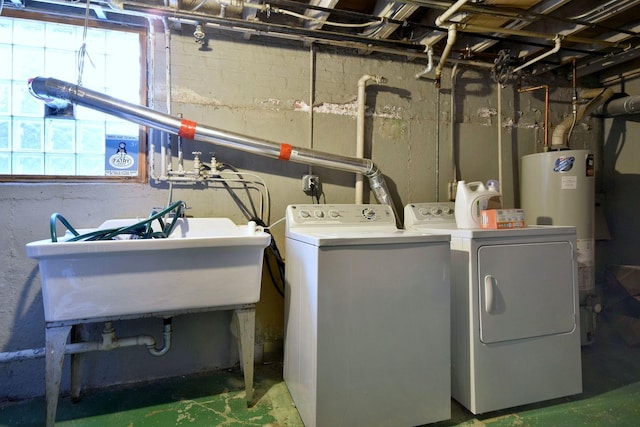 clothes washing area featuring laundry area, washing machine and clothes dryer, gas water heater, and a healthy amount of sunlight