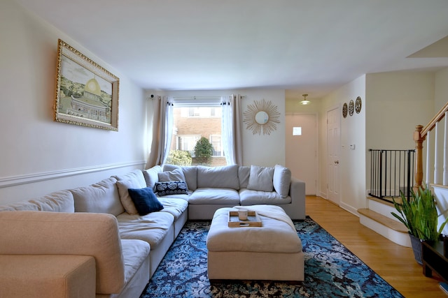 living room with light wood-style floors and stairs