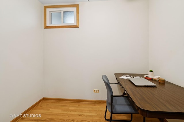office with light wood-style floors and baseboards