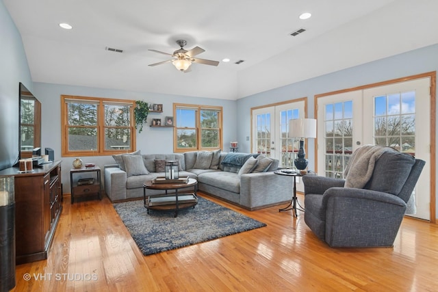 living area with visible vents, ceiling fan, light wood-style floors, and a healthy amount of sunlight