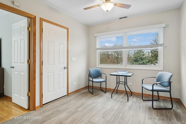 sitting room featuring visible vents, ceiling fan, light wood finished floors, and plenty of natural light