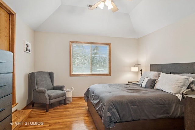 bedroom with ceiling fan, light wood-type flooring, and lofted ceiling