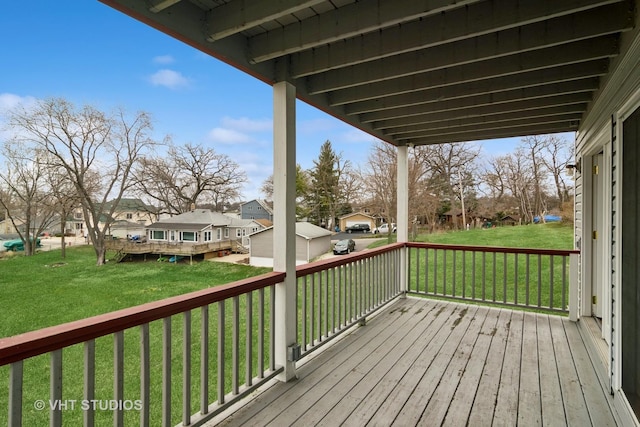 wooden terrace featuring a yard and a residential view