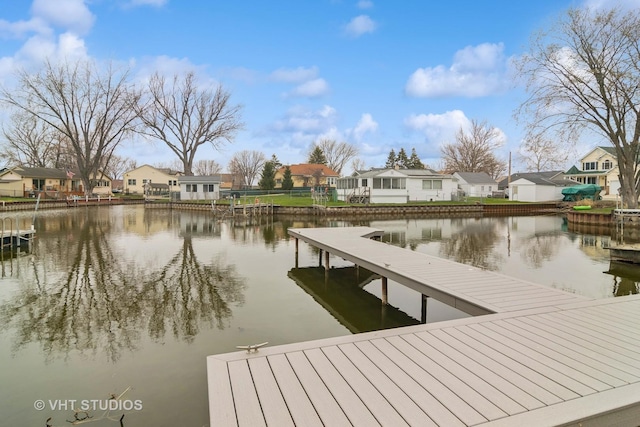 dock area featuring a water view and a residential view