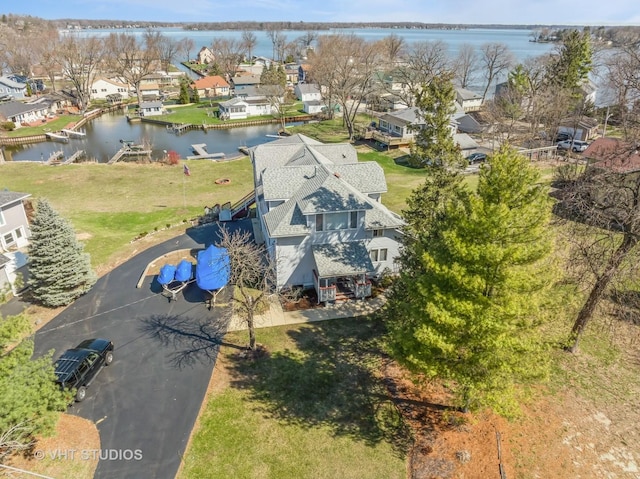 bird's eye view featuring a water view and a residential view