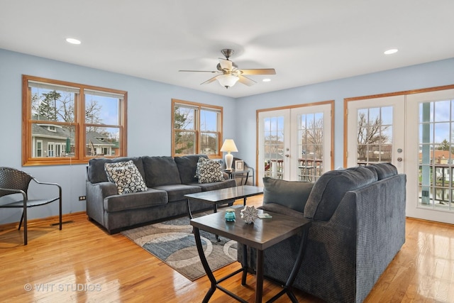 living room featuring light wood-type flooring, french doors, a ceiling fan, and recessed lighting