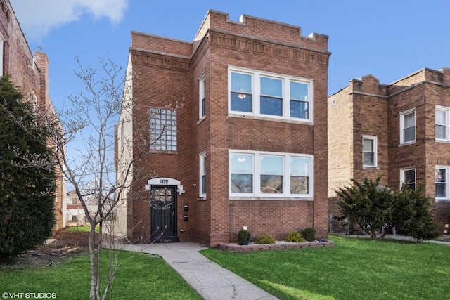 view of front facade with brick siding and a front lawn
