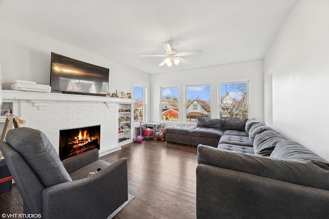 living room featuring a fireplace, wood finished floors, and ceiling fan