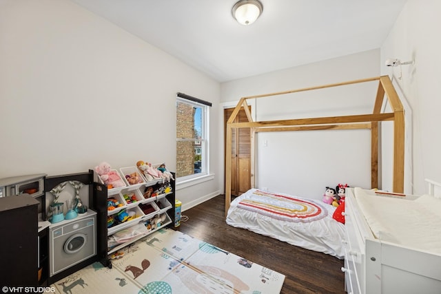 bedroom with wood finished floors and baseboards